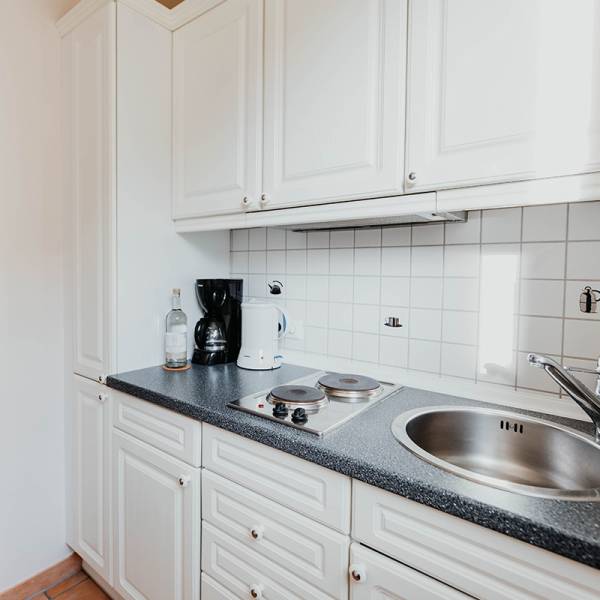 Eine Küchenzeile mit allen nötigen Ausstattungen in einer Junior Suite im Hotel Hüttmann auf Amrum.